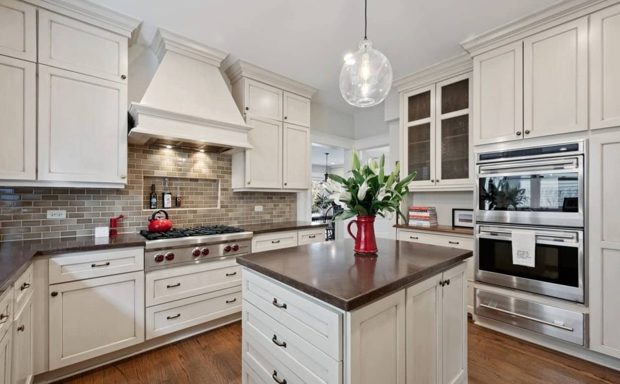 Modern kitchen with white cabinetry, stainless steel appliances, and dark countertops
